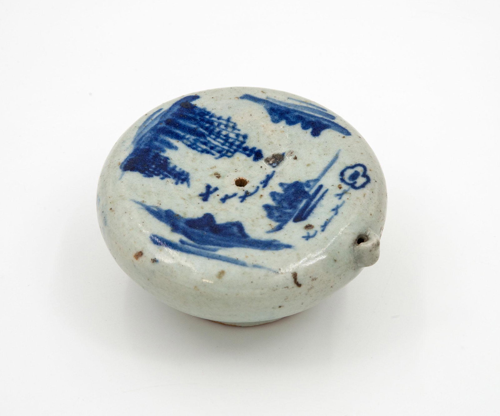 A Large Blue and White Porcelain Water Dropper, Korea, Joseon Dynasty (1392-1910): A Large Blue and White Porcelain Water Dropper, Korea, Joseon Dynasty (1392-1910) Rounded body raised on a circular support and the top decorated with landscapes. Height: 5.8 cm; diameter: 10.7 cm Pr