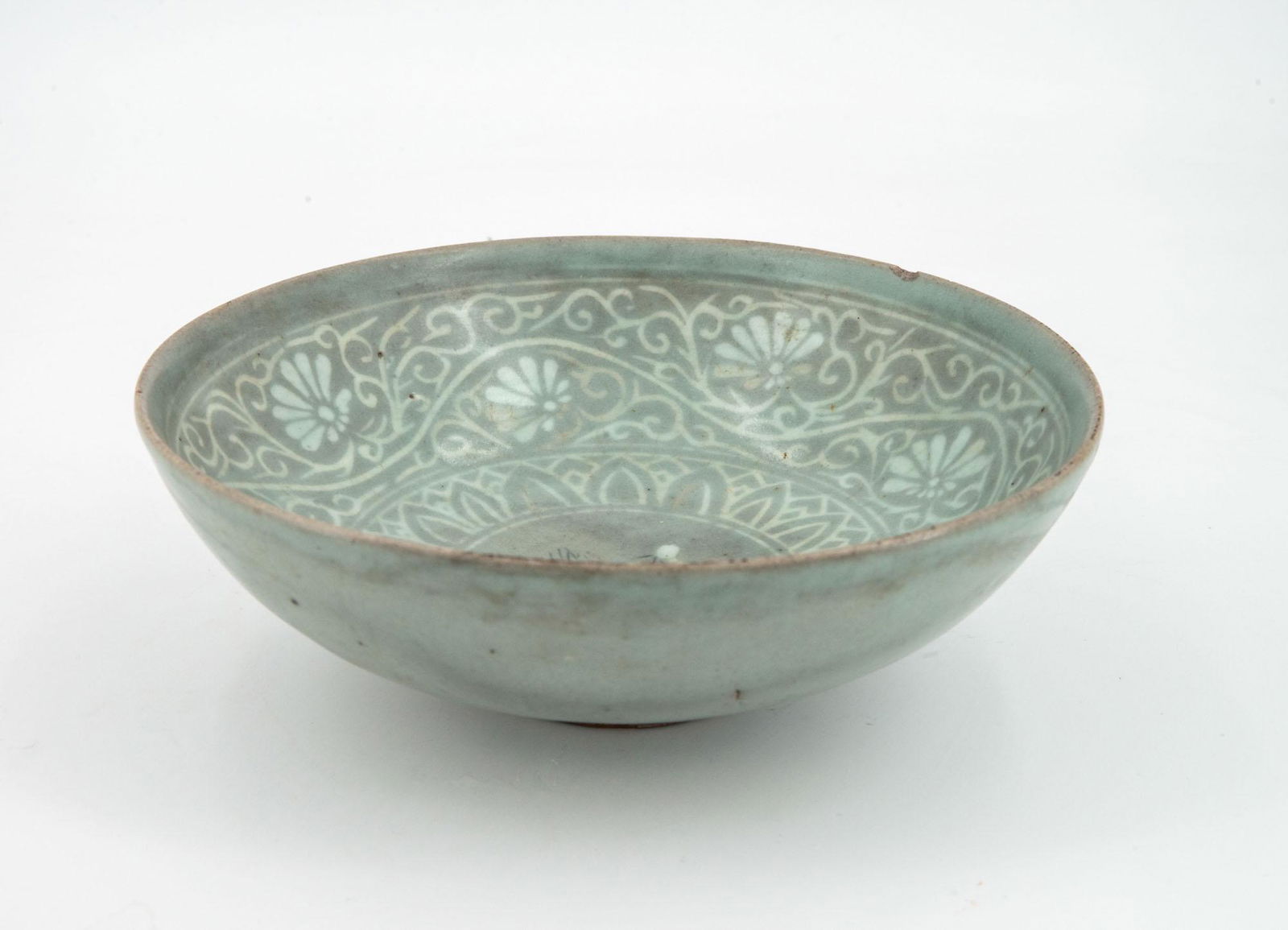 A Rare Celadon Stoneware Bowl, Korea, Goryeo Dynasty, 13/14th Century: A Rare Celadon Stoneware Bowl, Korea, Goryeo Dynasty, 13/14th Century Stoneware with white and black inlays under celadon glaze. Diameter: 18 cm; height: 6.5 cm Note: Tiny chip on the rim.