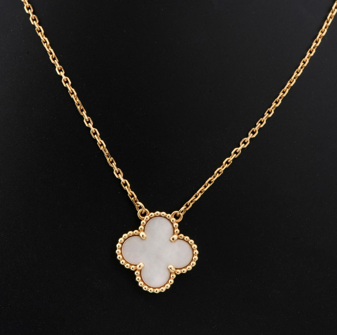A Pair of Vintage Van Cleef and Arpels "Alhambra" 18K Gold and Mother of Pearl Pendant: A Pair of Vintage Van Cleef and Arpels "Alhambra" 18K Gold and Mother of Pearl Pendant Designed as mother of pearl quatrefoil with a raised beaded border and suspended from trace-link chain. Signed an