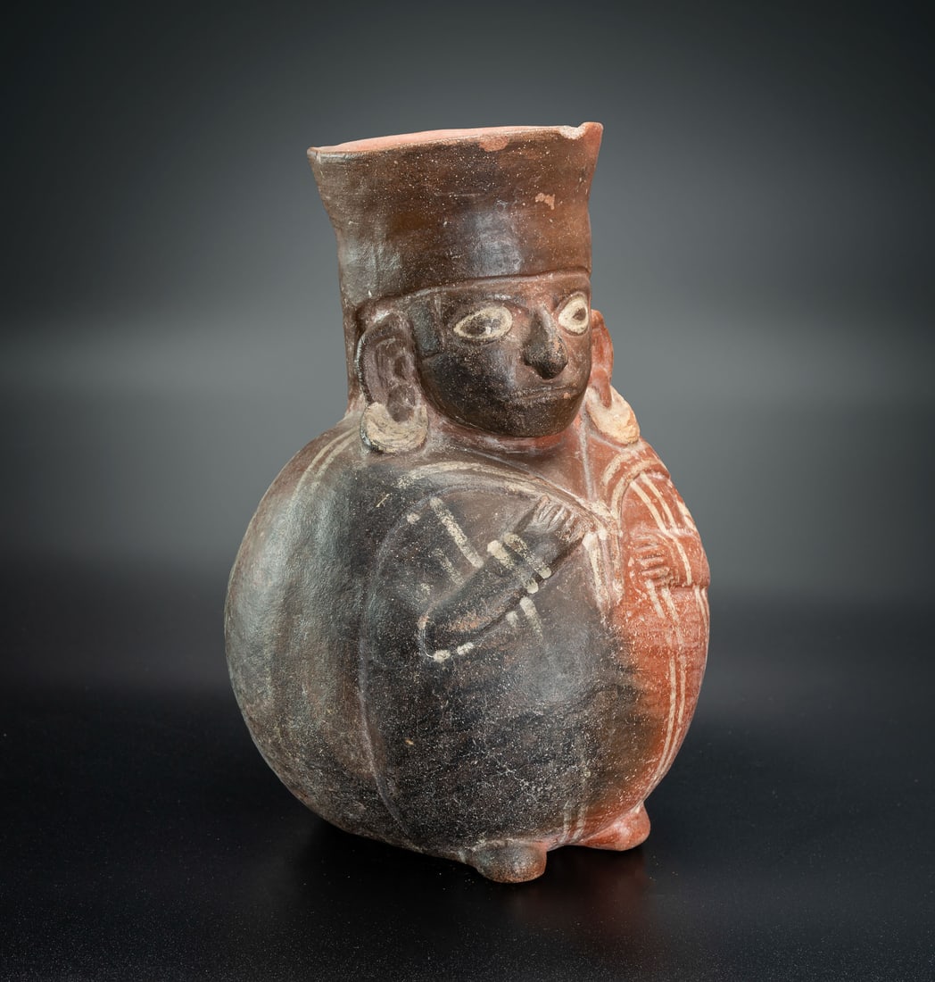 A Spouted Bottle Decorated with a Relief of a Priest, Middle Nasca, Peru, 100-300 CE: A Spouted Bottle Decorated with a Relief of a Priest, Middle Nasca, Peru, 100-300 CE Height: 322 cm Provenance: Jean Pierre Cottier and Fiorella Cottier-Angeli, Geneva, Switzerland. Purchased by