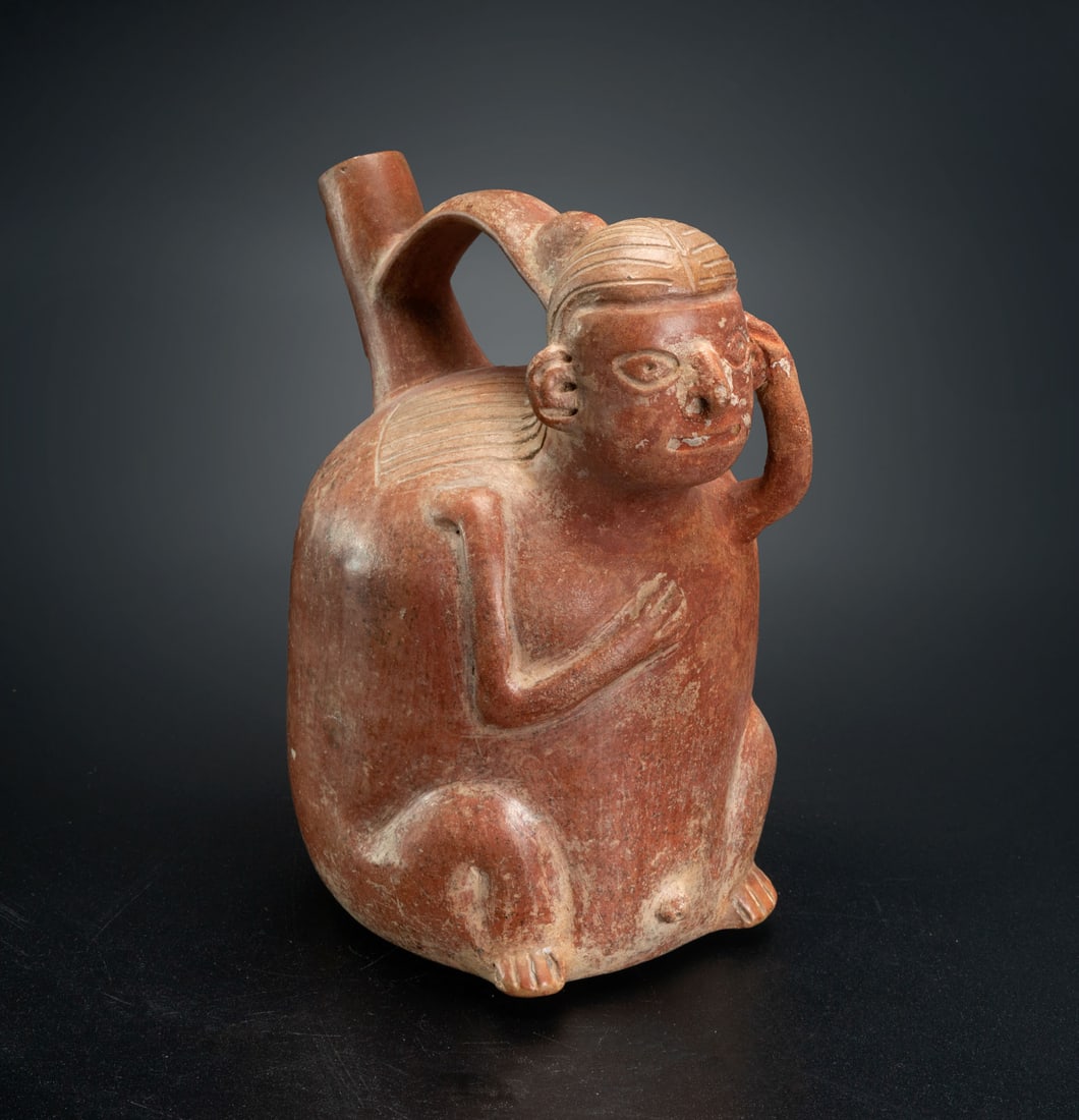 A Spout-and-Handle Whistling Effigy Bottle: Seated Male, Salinar, Peru, 200 BCE-100 CE: A Spout-and-Handle Whistling Effigy Bottle: Seated Male, Salinar, Peru, 200 BCE-100 CE Height: 17.7 cm For more details on this lot refer to the following number in the link: num 133, p. 154 (