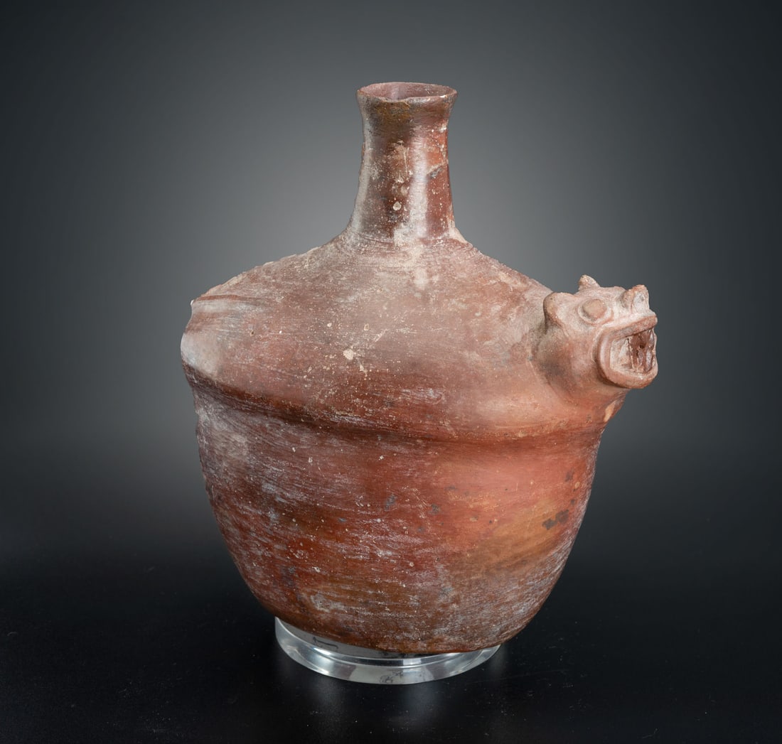 A Spouted Bottle with Feline Head Decoration, Vicus, Peru, 200 BCE-800 CE: A Spouted Bottle with Feline Head Decoration, Vicus, Peru, 200 BCE-800 CE Height: 22.7 cm For more details on this lot refer to the following number in the link: num 137, p. 154 (