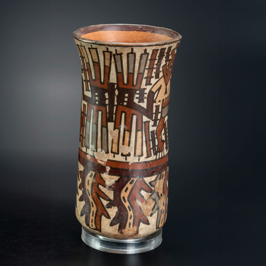 A Beaker with Painted Depiction of Warriors, Late Nasca, Peru, 300-600 CE: A Beaker with Painted Depiction of Warriors, Late Nasca, Peru, 300-600 CE A representation of two warriors holding three spears in each hands. The are wearing headdress with feather tufts, short tunic