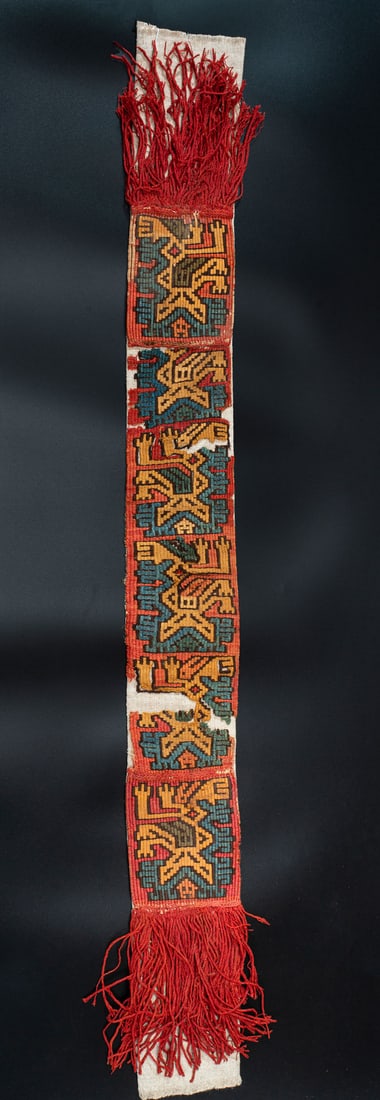 A Band with Fringes Showing Mythical Beings, Central-South Coast, Peru, Middle Horizon, 500-700 CE: A Band with Fringes Showing Mythical Beings, Central-South Coast, Peru, Middle Horizon, 500-700 CE Late Nasca Multicolored cotton and camelid fiber slit tapestry, stem stitch and plain weave. 12.5 x 1