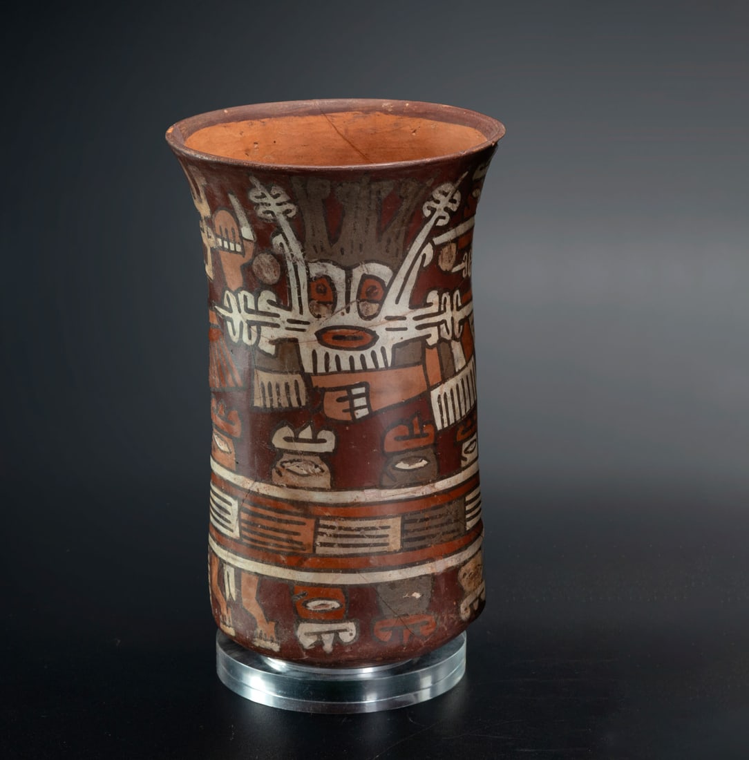 A Beaker with Two Depictions of the Anthropomorphic Mythical Being, Late Nasca, Peru, 300-600 CE: A Beaker with Two Depictions of the Anthropomorphic Mythical Being, Late Nasca, Peru, 300-600 CE Tall beaker with two similar representations of mythical personages depicted with feline mouth masks, h