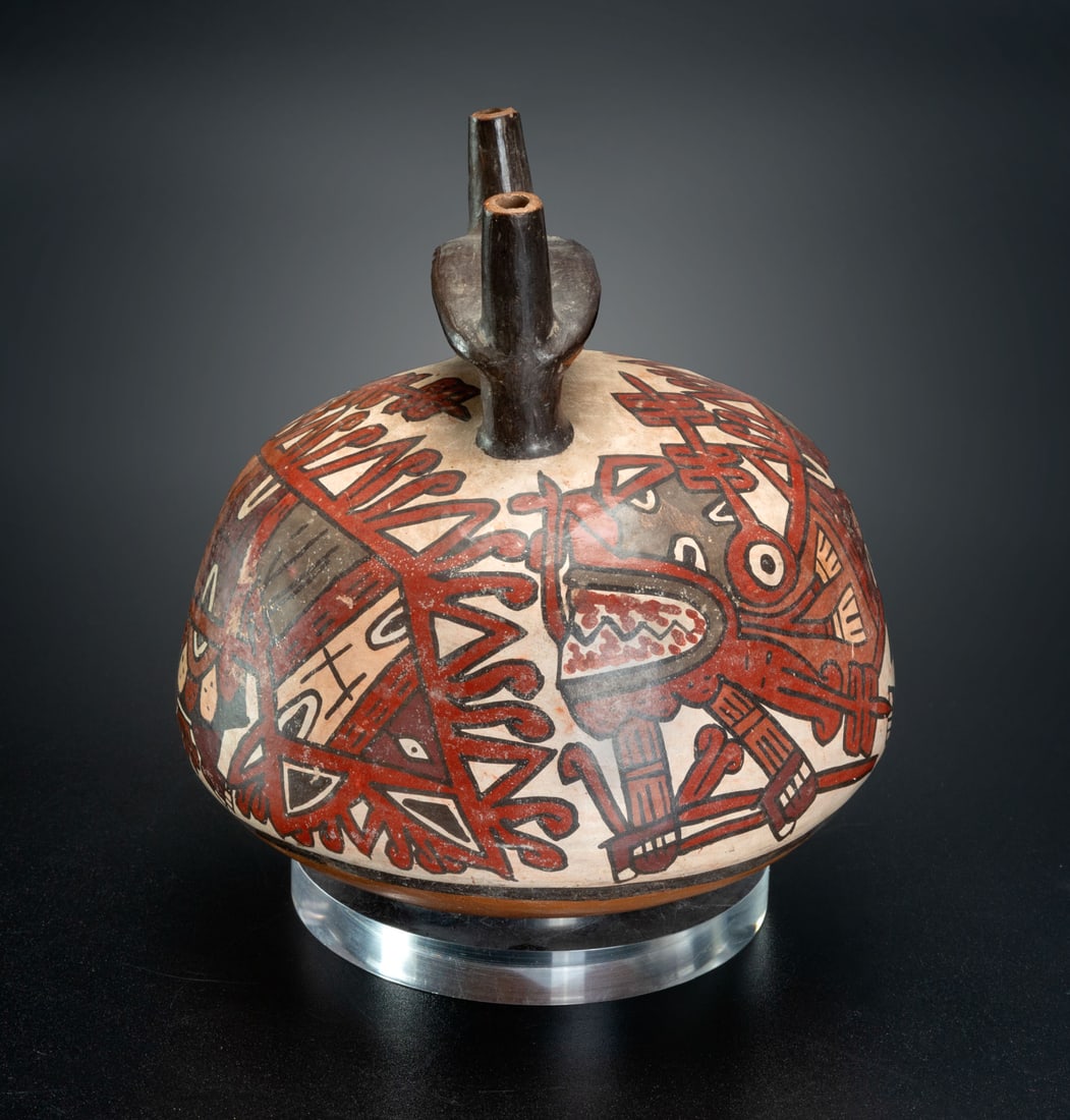 A Double Spout-and-Bridge Bottle with a Mythical Killer Whale, Late Nasca, Peru, 300-600 CE: A Double Spout-and-Bridge Bottle with a Mythical Killer Whale, Late Nasca, Peru, 300-600 CE The bottle decorated with two very similar Mythical Killer Whale depictions. This being has gaping jaws cove