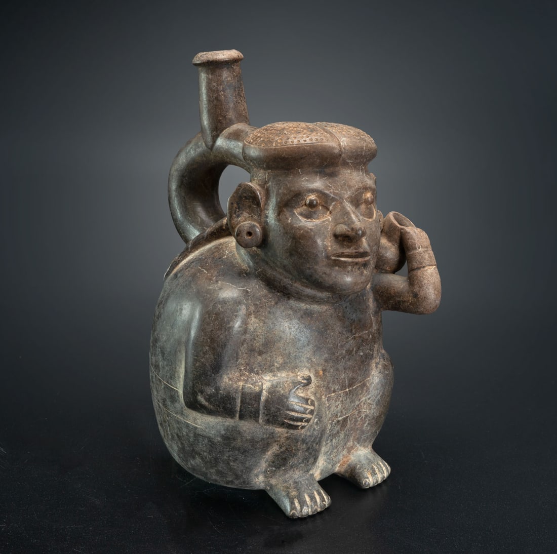 A Stirrup Spout Effigy Bottle: Squatting Man Holding a Jar, Early Moche, Peru, 100-450 CE (1 of 5)