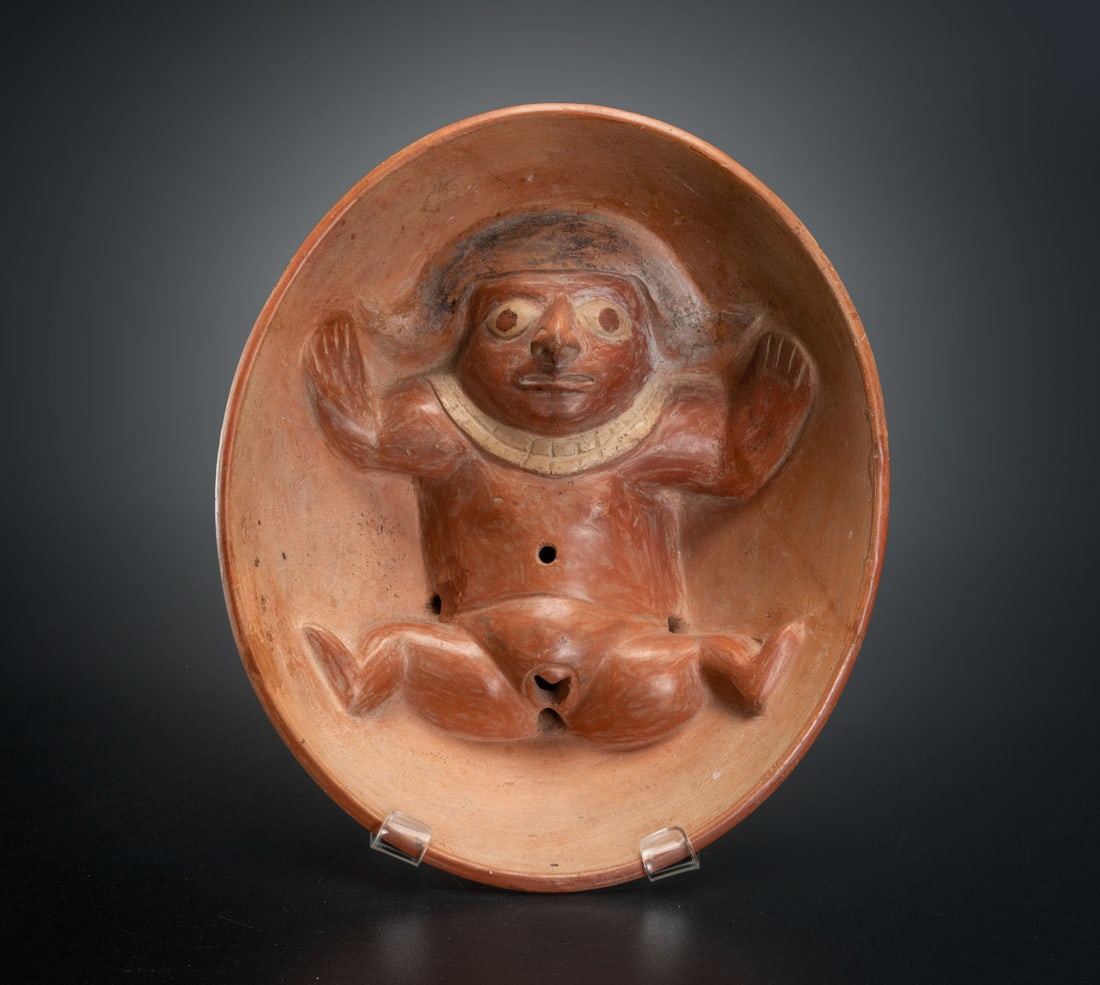 An Effigy Bow: Nude Female, Early Moche, Peru, 100-450 CE: An Effigy Bow: Nude Female, Early Moche, Peru, 100-450 CE Ritual double-bottomed vessel for drinking or pouring liquids. The vulva, anis , navel and two additional openings of the presented nude femal