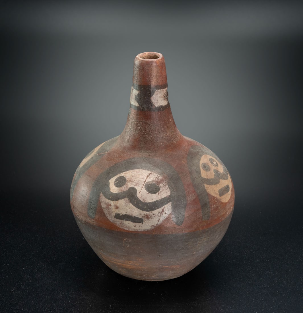 A Spout Bottle Decorated with a Female Likeness, Chavin, Peru, 900 BCE - 500 CE: A Spout Bottle Decorated with a Female Likeness, Chavin, Peru, 900 BCE - 500 CE Height: 31.5cm Provenance: Jean Pierre Cottier and Fiorella Cottier-Angeli, Geneva, Switzerland. Purchased by Yossef Mai