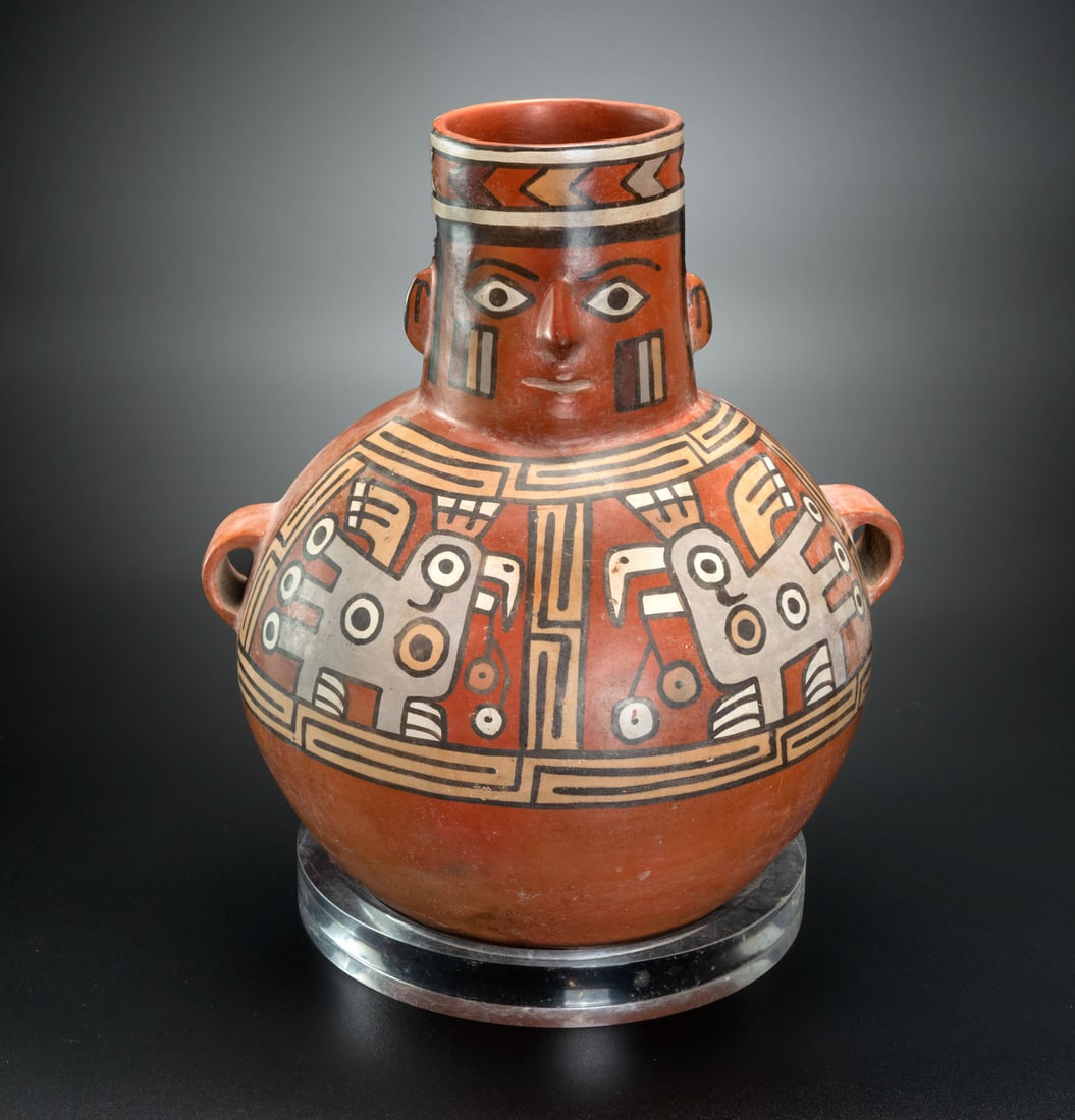 A Spout-and-Handle Jar: Huari Personage, Huari-Related Local Style, Peru, 600-1100 CE: A Spout-and-Handle Jar: Huari Personage, Huari-Related Local Style, Peru, 600-1100 CE A jar with an anthropomorphic effigy spout representing a lavishly dressed Huari personage with a simple headdress