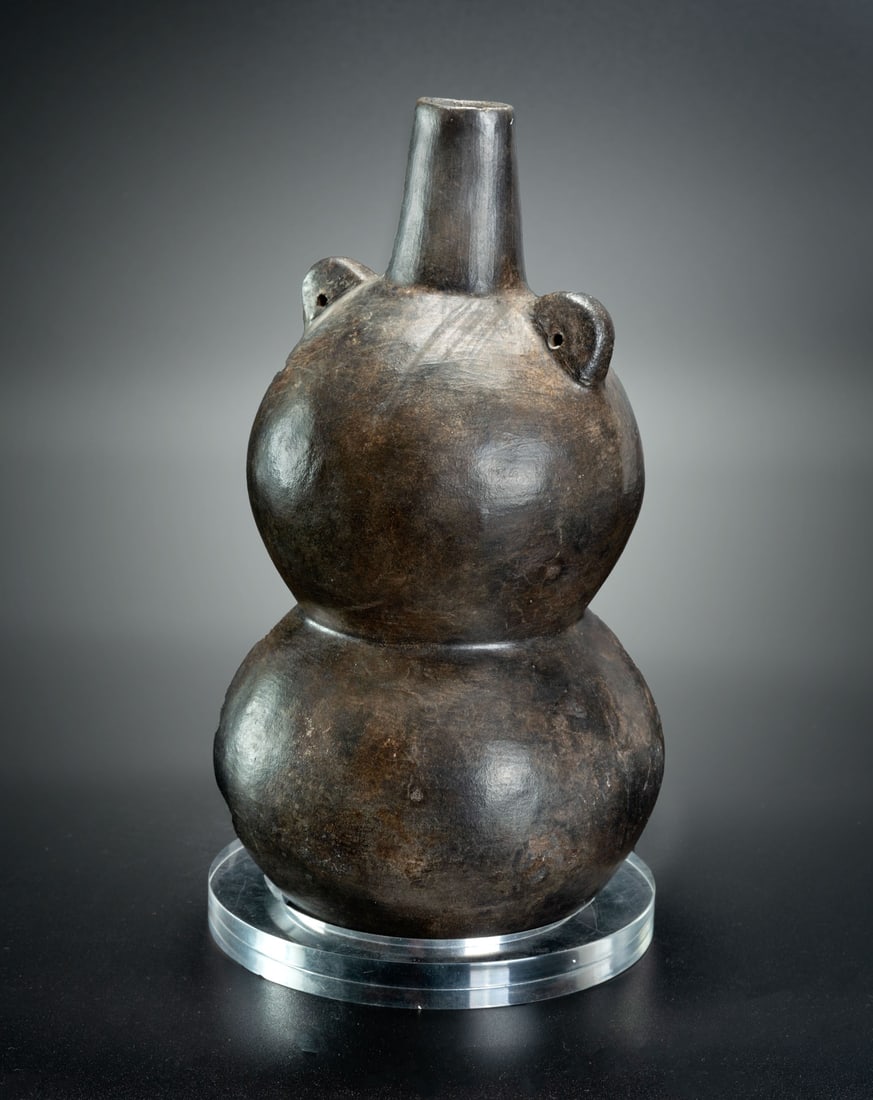 A Double Globular Spout-and-Handle Phytomorphic Bottle, Lambayeque, 750-1350 CE: A Double Globular Spout-and-Handle Phytomorphic Bottle, Lambayeque, 750-1350 CE Height: 21.5 cm For more details on this lot refer to the following number in the link: num 205, p. 162 (