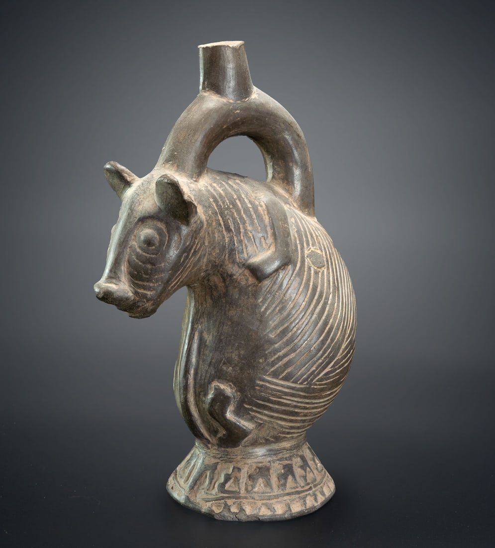 A Stirrup-Spout Effigy Bottle with a Pedestal: Hairless Dog, Lambayeque, 750-1350 CE: A Stirrup-Spout Effigy Bottle with a Pedestal: Hairless Dog, Lambayeque, 750-1350 CE Height: 22 cm For more details on this lot refer to the following number in the link: num 207, p. 162 (