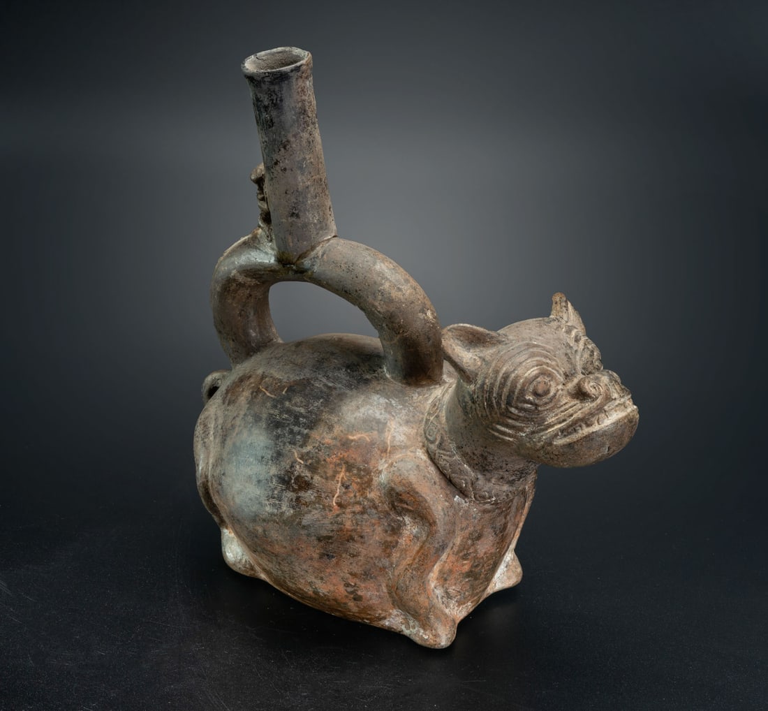 A Stirrup-Spout Effigy Bottle: Hairless Dog, Chimu, Peru, 900-1534 CE: A Stirrup-Spout Effigy Bottle: Hairless Dog, Chimu, Peru, 900-1534 CE Height: 19.8 cm For more details on this lot refer to the following number in the link: num 218, p. 163 (