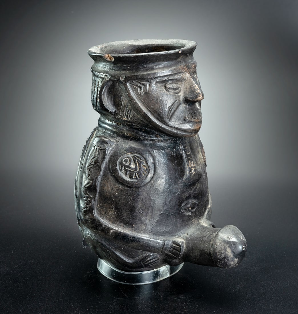 An Effigy Jar: Ithyphallic Man, Chimu, Peru, 900-1470 CE: An Effigy Jar: Ithyphallic Man, Chimu, Peru, 900-1470 CE An effigy jar in the shape of a schematically-rendered ithyphallic man, seated and holding his oversized penis. The male - probably a supernatu
