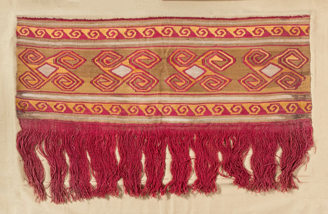 A Mantle Border with Hooked Diamonds, Central Coast, Peru, Early and Middle Late Intermediate: A Mantle Border with Hooked Diamonds, Central Coast, Peru, Early and Middle Late Intermediate Period, 900-1350 CE Local Style Multicolored cotton and camelid fiber slit tapestry and weft-faced stripes