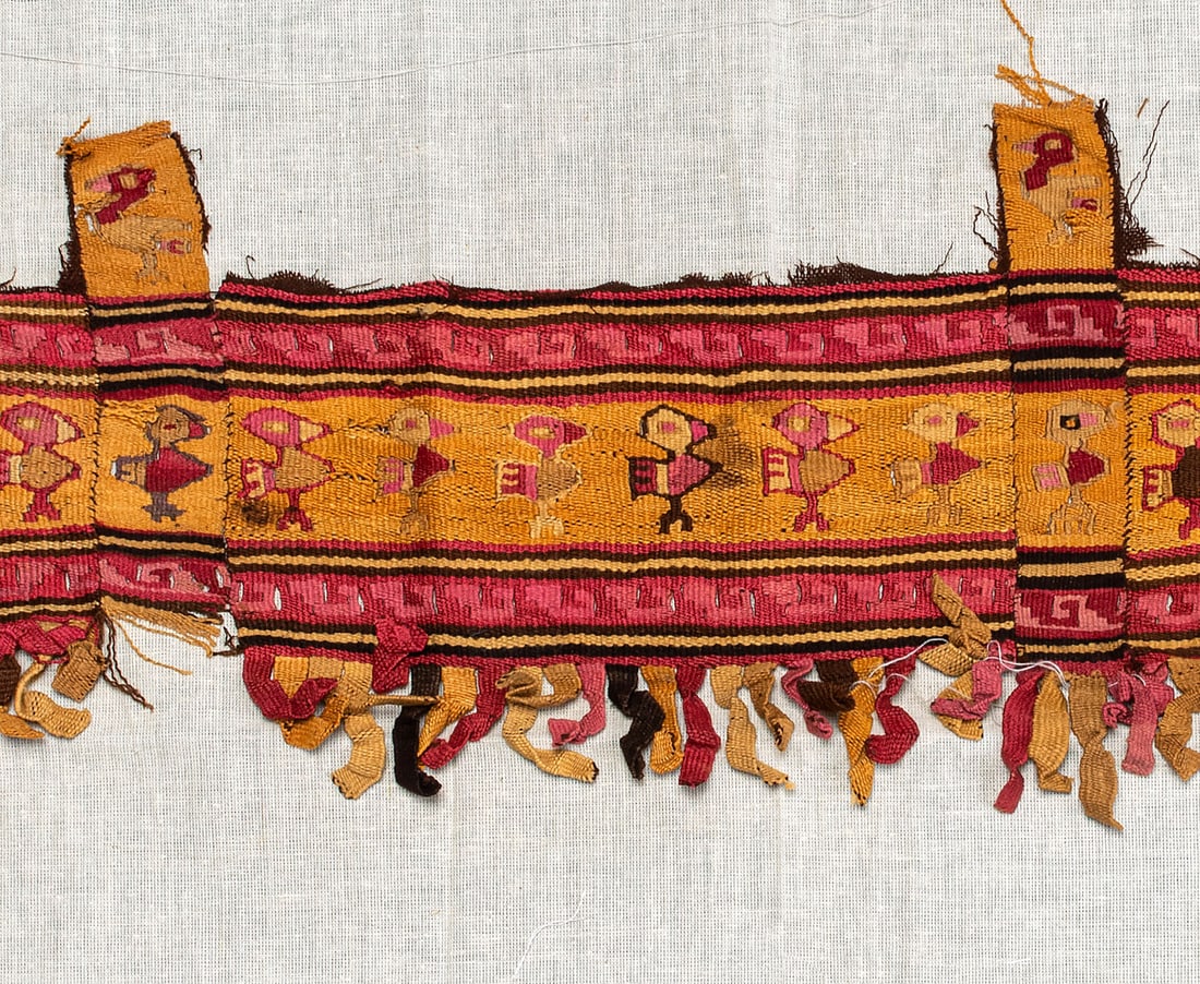A Border of a Mantle with Birds, Central Coast, Peru, Late Intermediate Period, 1100-1470 CE: A Border of a Mantle with Birds, Central Coast, Peru, Late Intermediate Period, 1100-1470 CE Local Style Dark brown cotton and multicolored camelid fiber slit tapestry. 24 x 124 cm <