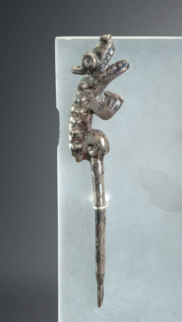 A Silver Spatula with Animal-Shaped Handle, Chimu, Peru, 900-1470 CE: A Silver Spatula with Animal-Shaped Handle, Chimu, Peru, 900-1470 CE Silver lime spatula with modeled animal figurine at the top for use as a handle. Height: 9.3 cm For more details on this lot refer 