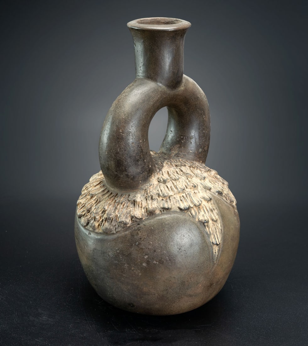 A Spout-and-Stirrup with Relief Decoration, Chavin, Peru, 1200-200 BCE: A Spout-and-Stirrup with Relief Decoration, Chavin, Peru, 1200-200 BCE Height: 23.7 cm Provenance: Jean Pierre Cottier and Fiorella Cottier-Angeli, Geneva, Switzerland. Purchased by Yossef Maiman betw