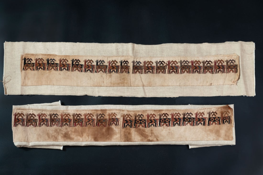 A Textile Band with Camelid and Stylized Figures, South Coast, Peru, Late Horizon, 1450-1550 CE: A Textile Band with Camelid and Stylized Figures, South Coast, Peru, Late Horizon, 1450-1550 CE Local Style, Inca Cotton and camelid fiber plain weave warp face with supplementary wefts (brocade) cros