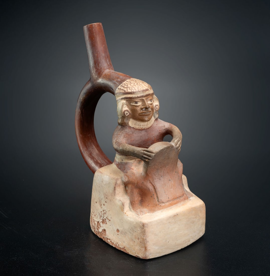 A Spout-and-Stirrup Bottle Depicting an Erotic Scene, Moche, Peru, 300-600 CE: A Spout-and-Stirrup Bottle Depicting an Erotic Scene, Moche, Peru, 300-600 CE Height: 21 cm Provenance: Kemper Collection, Switzerland. Donated to "The Museum of Islamic Art", Jerusalem, dur