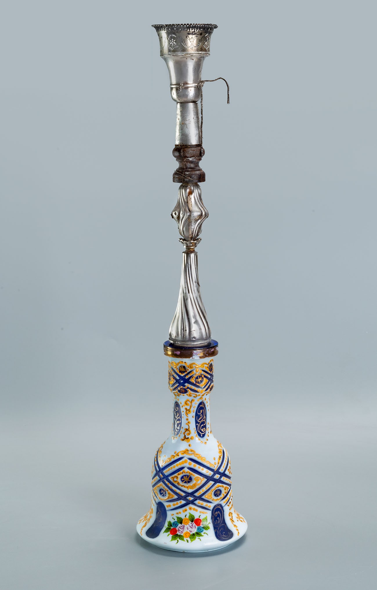 A Fine Islamic Silver and Bohemian Polychrome Glass Hookah, 19th Century: A Fine Islamic Silver and Bohemian Polychrome Glass Hookah, 19th Century The hookah base pained with clusters of flowers blue stripes and accented with gold. The pipe engraved with flowers and inscrib