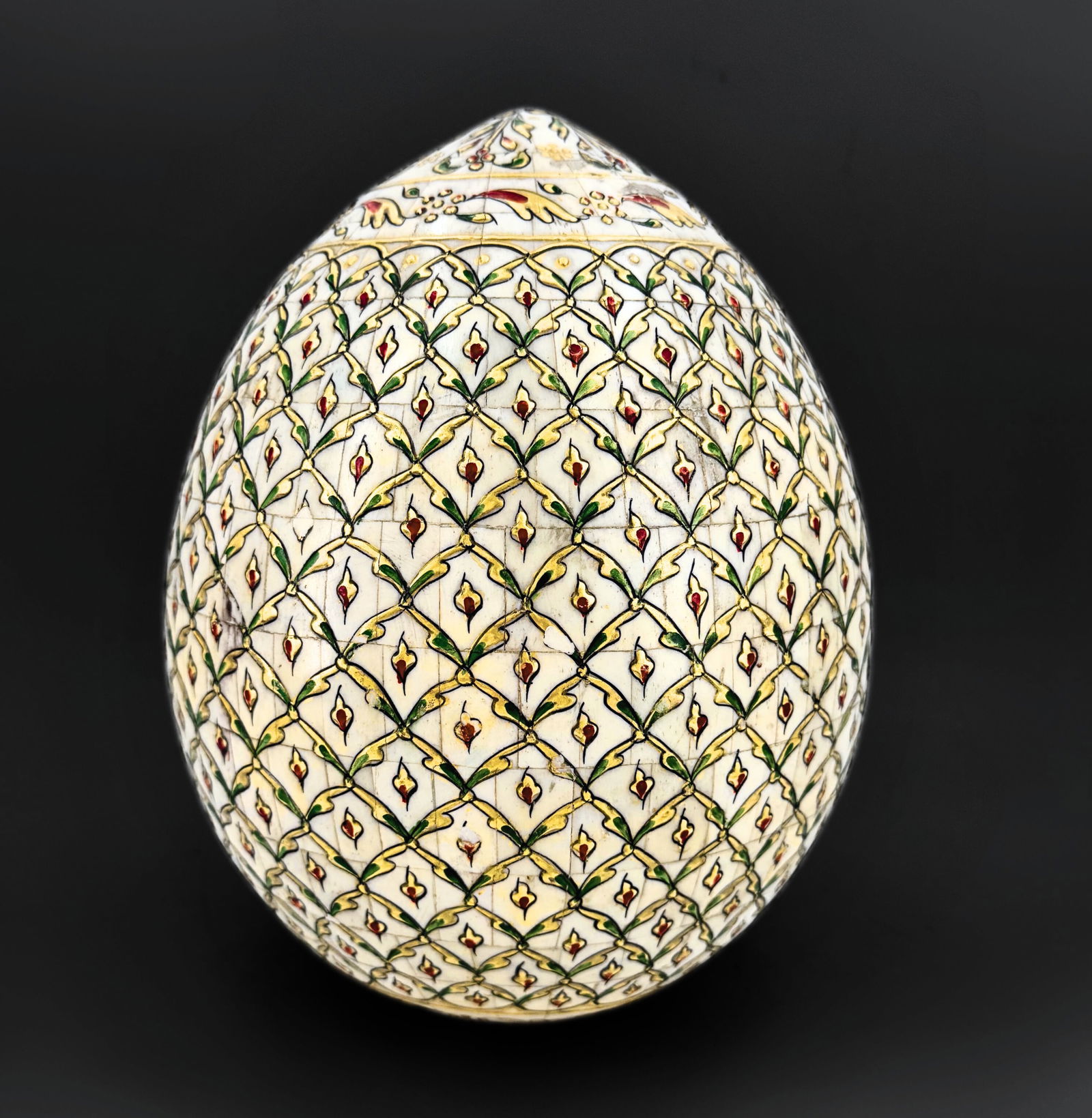 Decorative egg centerpiece, handcrafted from wood, in an Oriental style: Large decorative wooden egg, hand-painted and adorned with intricate floral and geometric designs in vivid polychrome colors, in the style of traditional Asian lacquer work. Dimensions: 26 &time