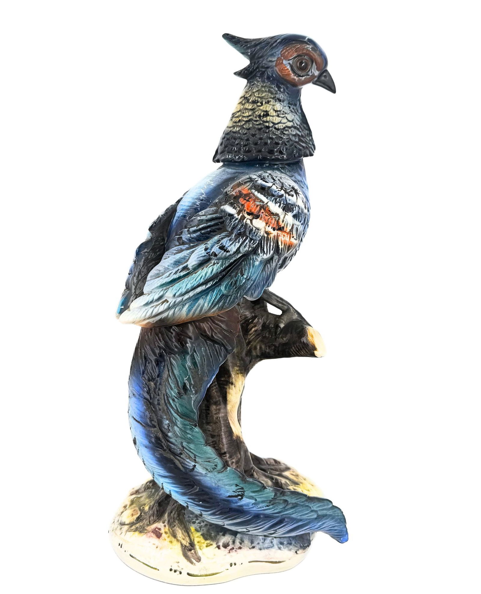An impressive figurine made of colorful porcelain, depicting a bird perched on a branch. Made by Cap: An impressive figurine made of colorful porcelain, depicting a bird perched on a branch.Made by Capodimonte, Italy. Height: 39.5 cm Provenance: Private collection, Konforti family Condition: For a d