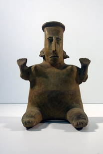 Nayarite ceramic figure of man seated: Ceramic Figurine. Nayarite (Pre-Columbian) 12" x 8.5", 6.5"Diameter