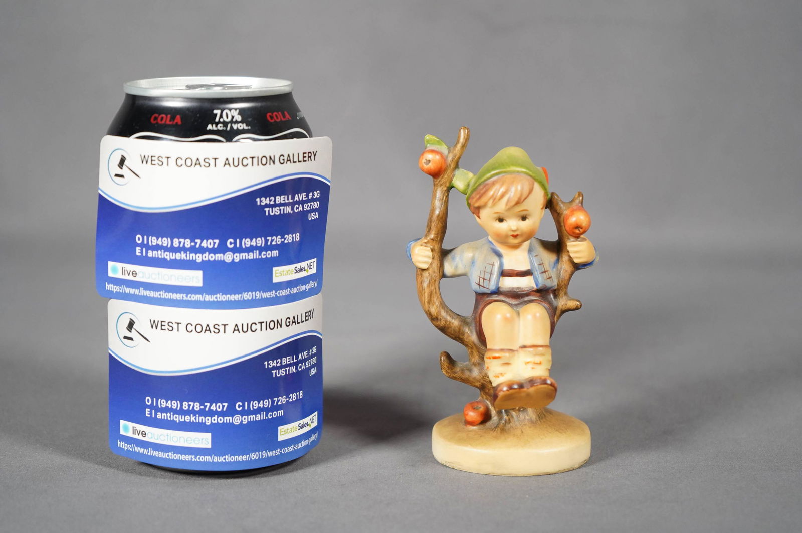 Hummel porcelain figure: A vintage Goebel Hummel, Germany little boy sitting on a tree. H: 4" x W: 2.5"