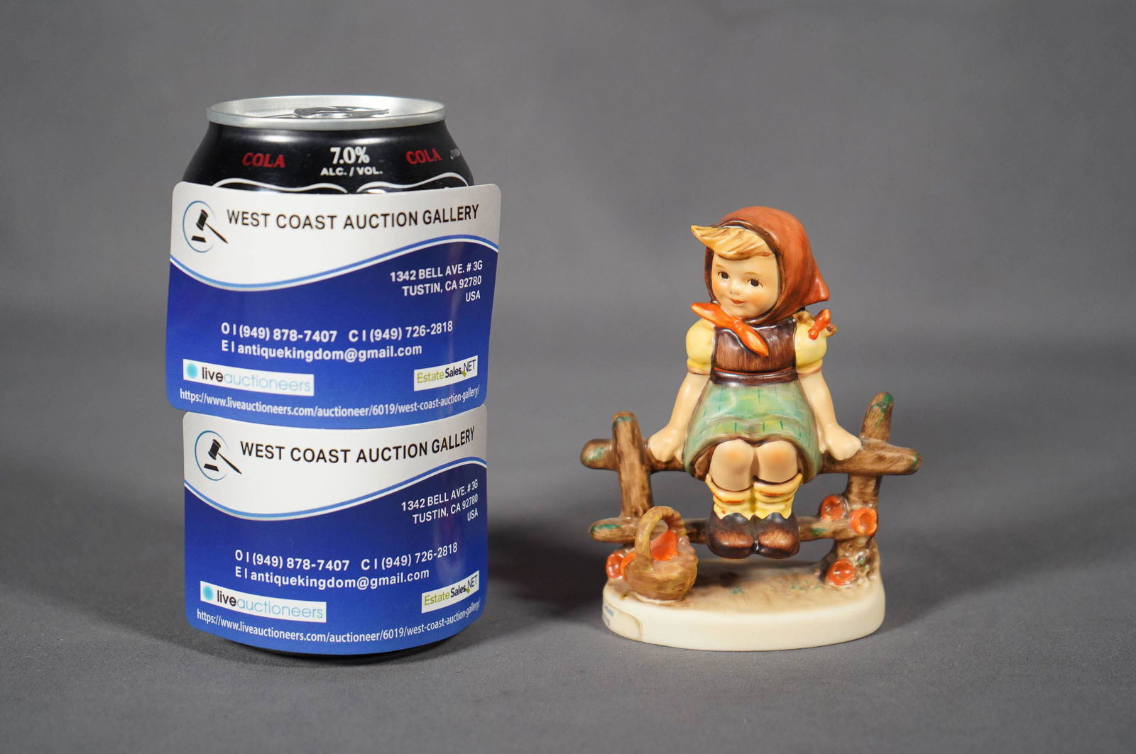 Hummel porcelain figure: A vintage Goebel Hummel, Germany little girl sitting on wooden fence. H: 4" x W: 2.75"