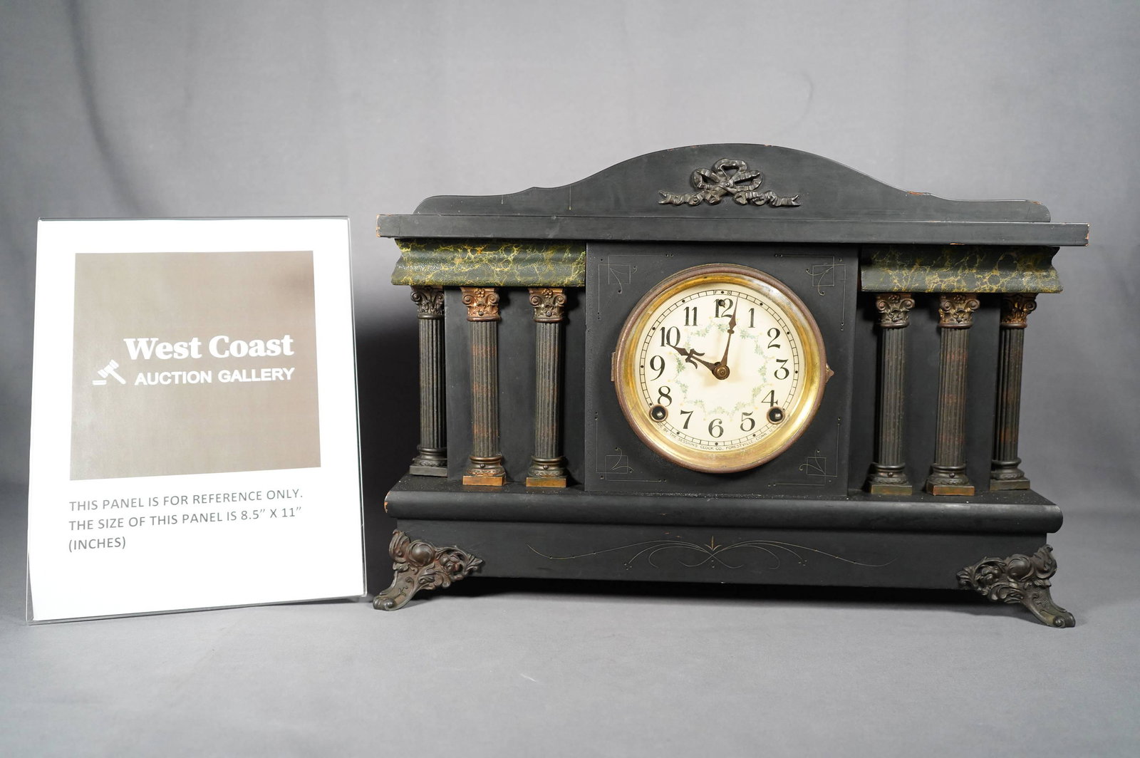 A heavy mantle clock: A heavy wooden decorated mantle clock. Condition selling it as is. H: 11" x W: 18"