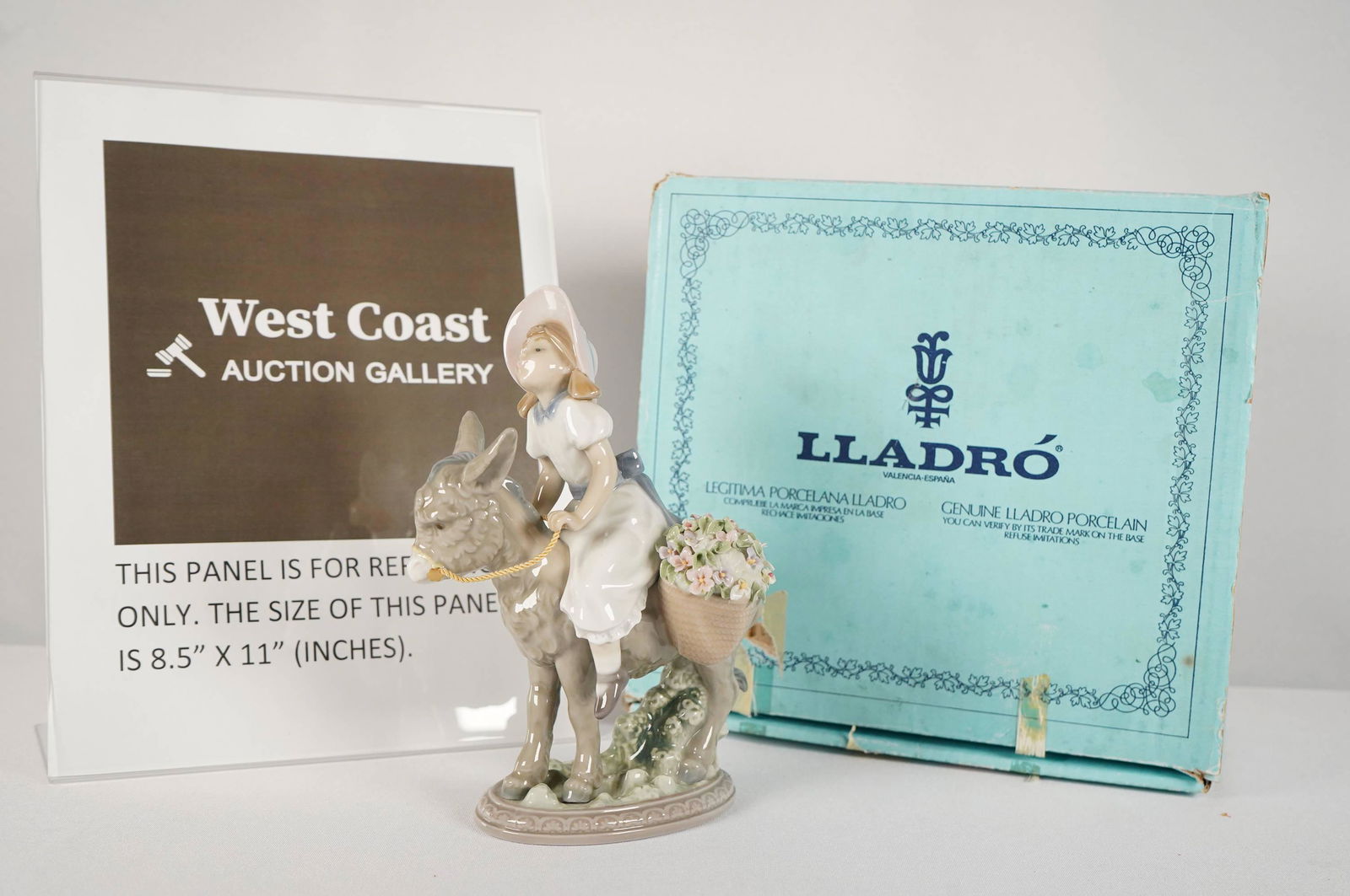 A Lladro girl with donkey: A Lladro girl figure riding on a donkey. Dated 1987 with orignal box. H: 8" x W: 5"