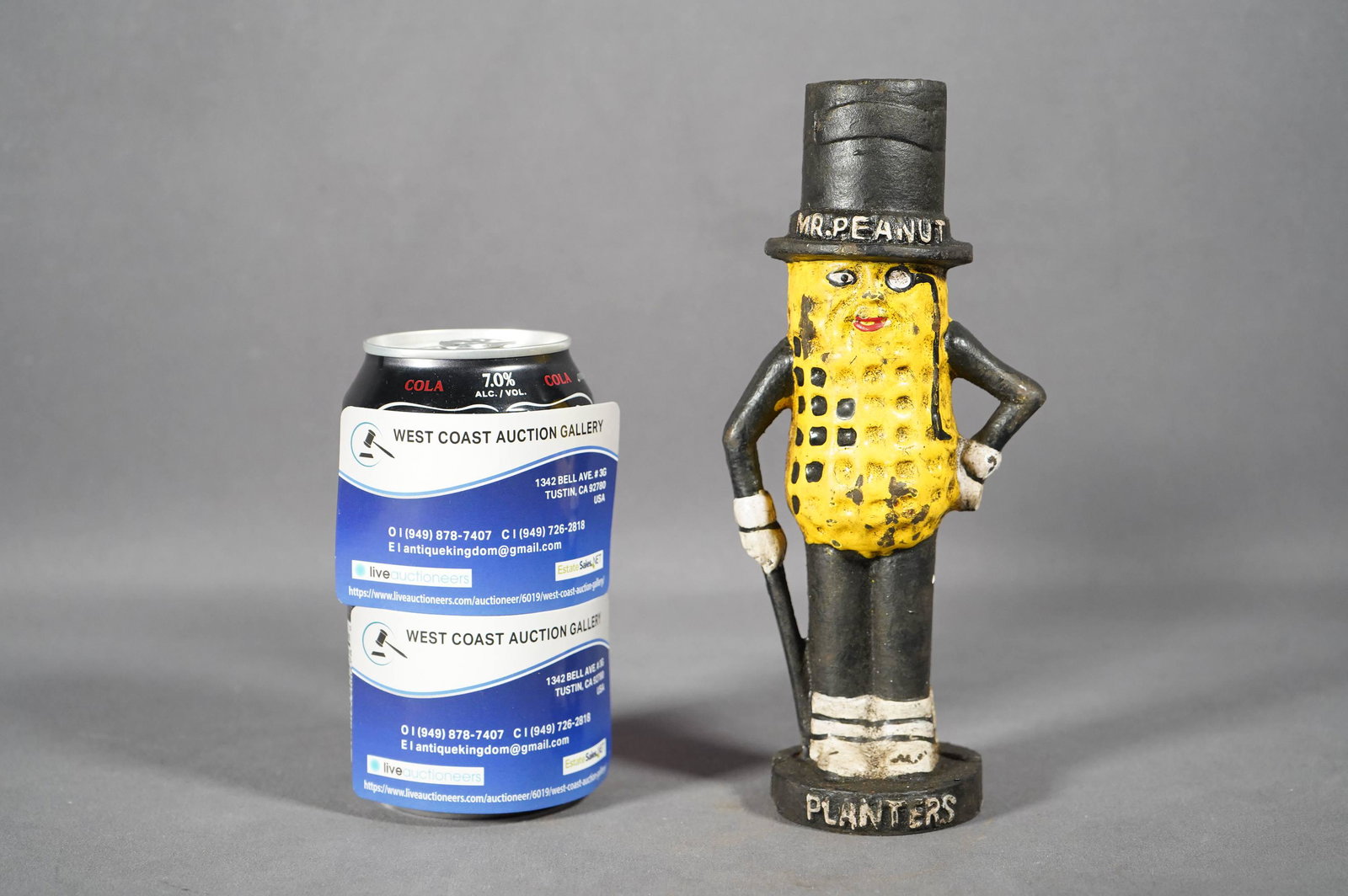 A cast iron bank: A vintage Mr. Peanut cast iron bank, with natural loss of paint. H: 7.5" x W: 3"