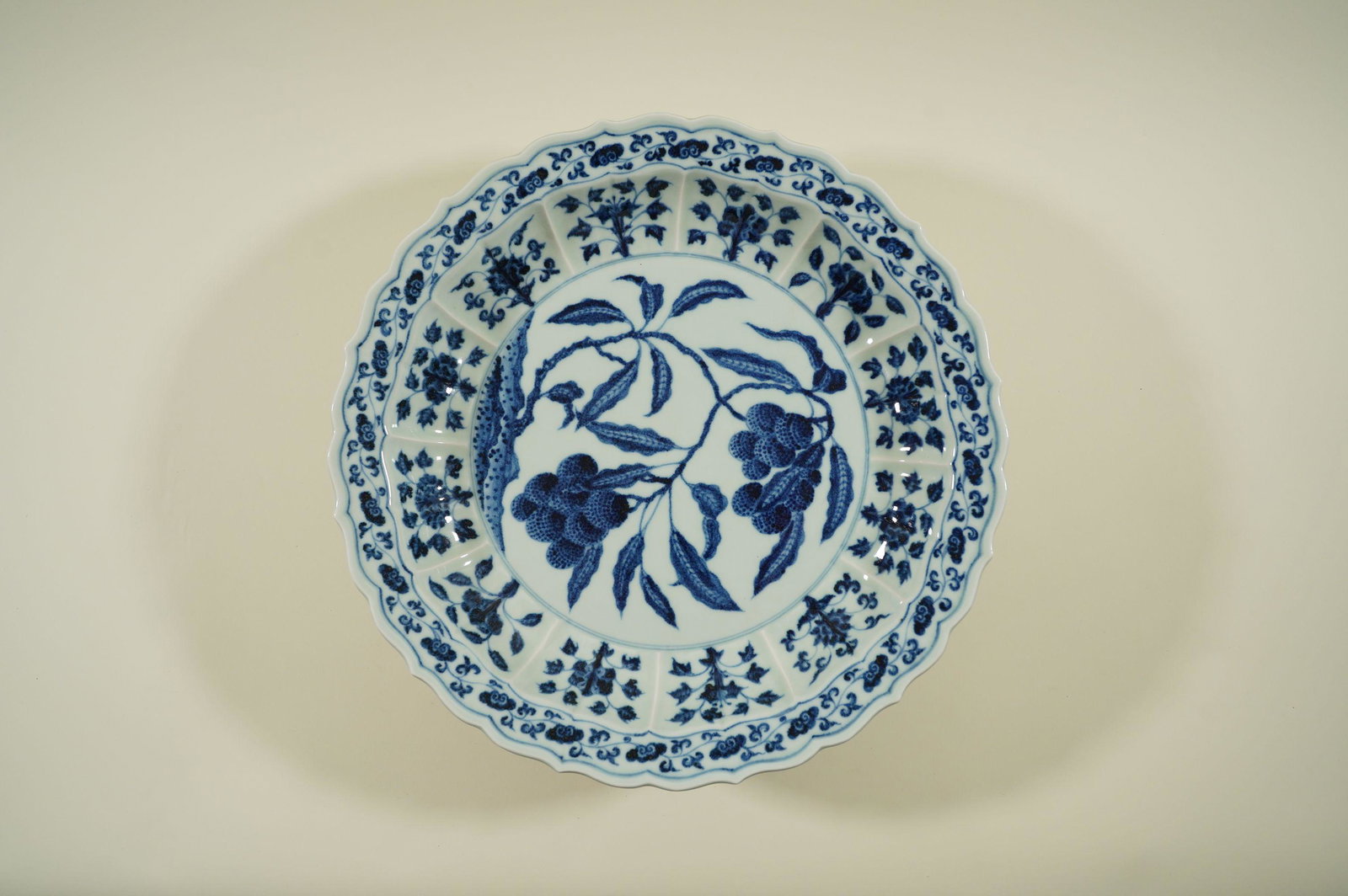 Chinese fine charger: Chinese vintage fine blue and white charger plate, with leaf and fruit motif. Estate of Laguna Hills. H: 2.75" x D: 18"