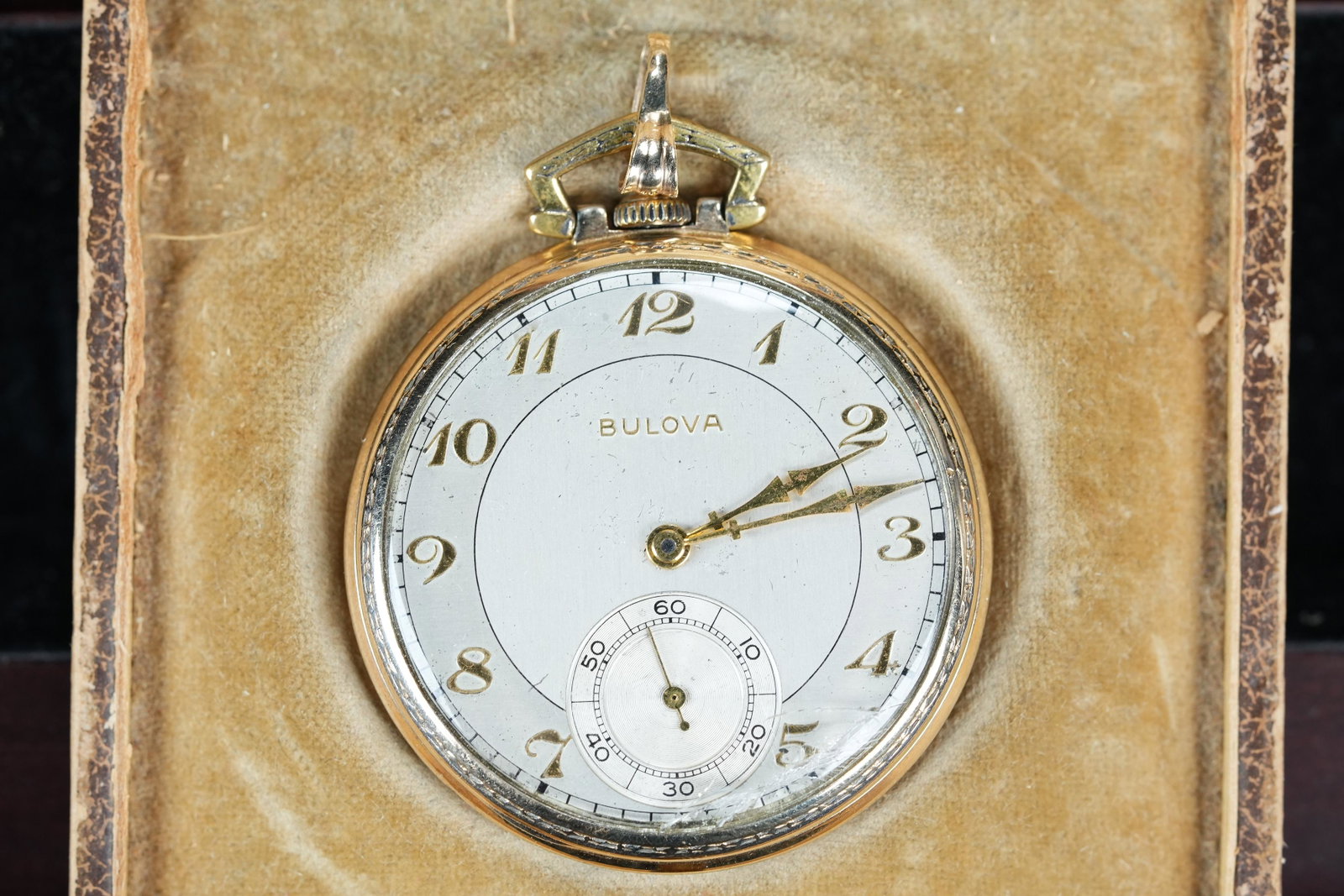 A Bulove pocket watch: A vintage Bulova pocket watch with original case. Condition selling it as is.