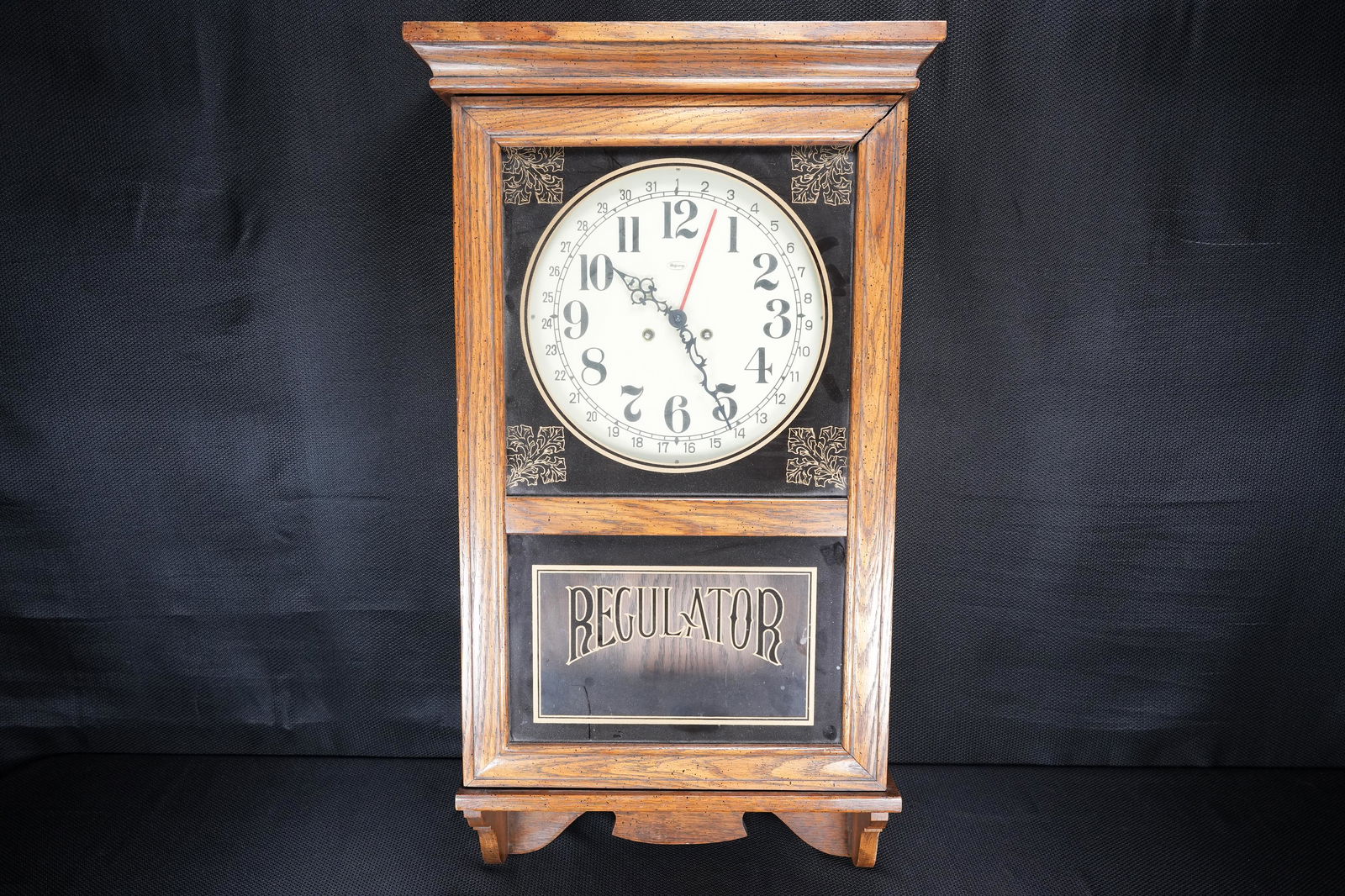 A wooden regulator clock: A vintage large wooden regulator clock. H: 34.25" x W: 17.7"