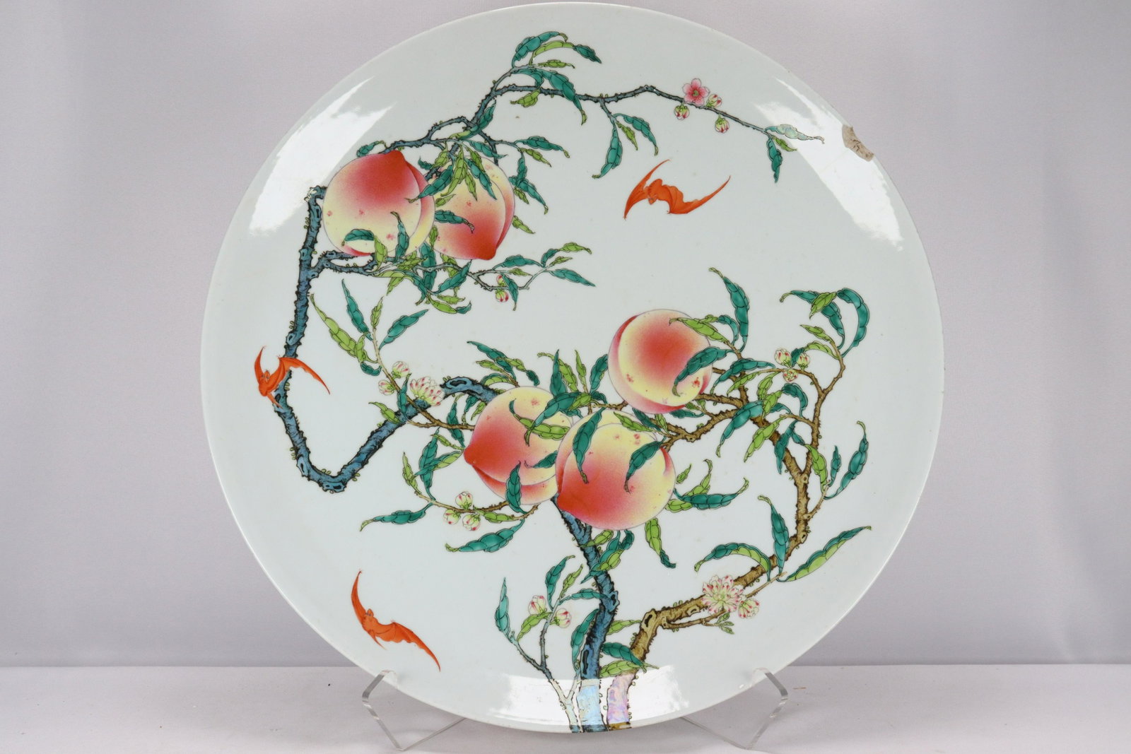 Chinese peach charger: Chinese peach charger plate, bottom has damage, condition selling it as is. Estate of San Diego. H: 3" x W: 20.25"
