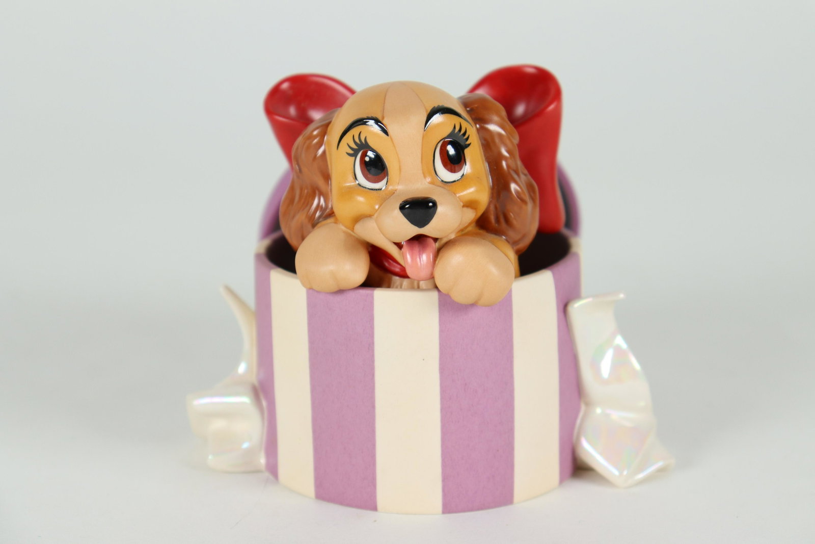 Lady WDC Disney figurine: Lady from Lady and the Tramp, Walt Disney Classics figurine. Comes with original box and COA. Miner flaw, plese refer to detail photos. H: 3.5" x W: 4.25"