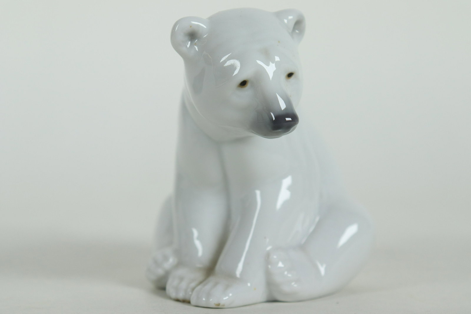 A Lladro polar bear: A Lladro porcelain figurine of a polar bear, with original box. H: 3.5" x W: 3.5."