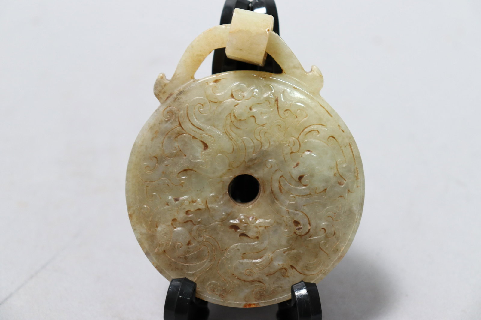 Chinese jade carved disc: Chinese celadon jade carved rounded disc. H: 3.5" x W: 3."