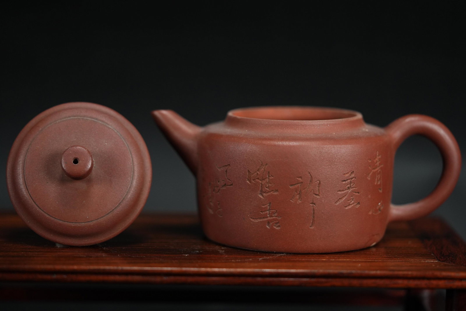 Chinese carved clay teapot: Chinese carved clay teapot. H: 4" x W: 6.75."