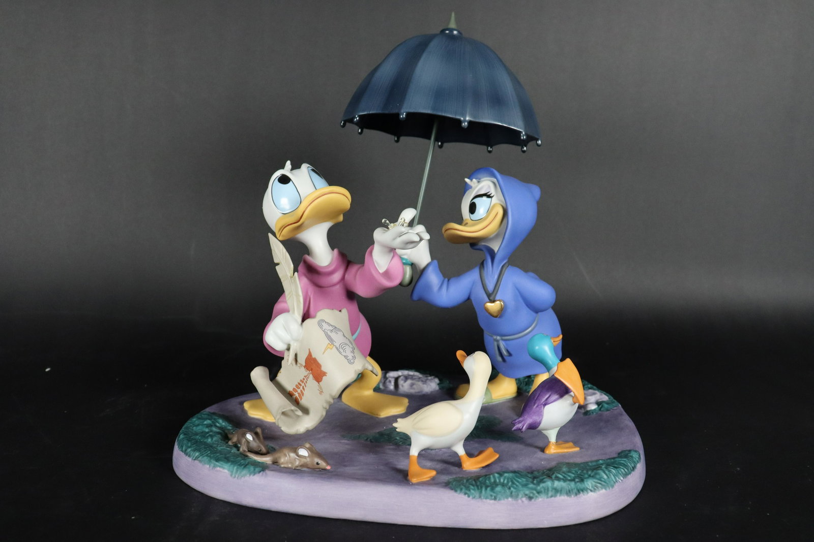 Fantasia WDC figurine: Fantasia 2000 fine WDC figurine. Donald and Daisy, dated year 2000. Comes with original box and COA. H: 10" x W: 10."