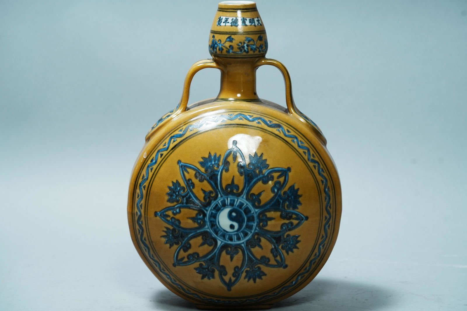 Chinese yellow flask vase: Chinese yellow glaze handled flask vase. H: 12.25" x W: 8.25."