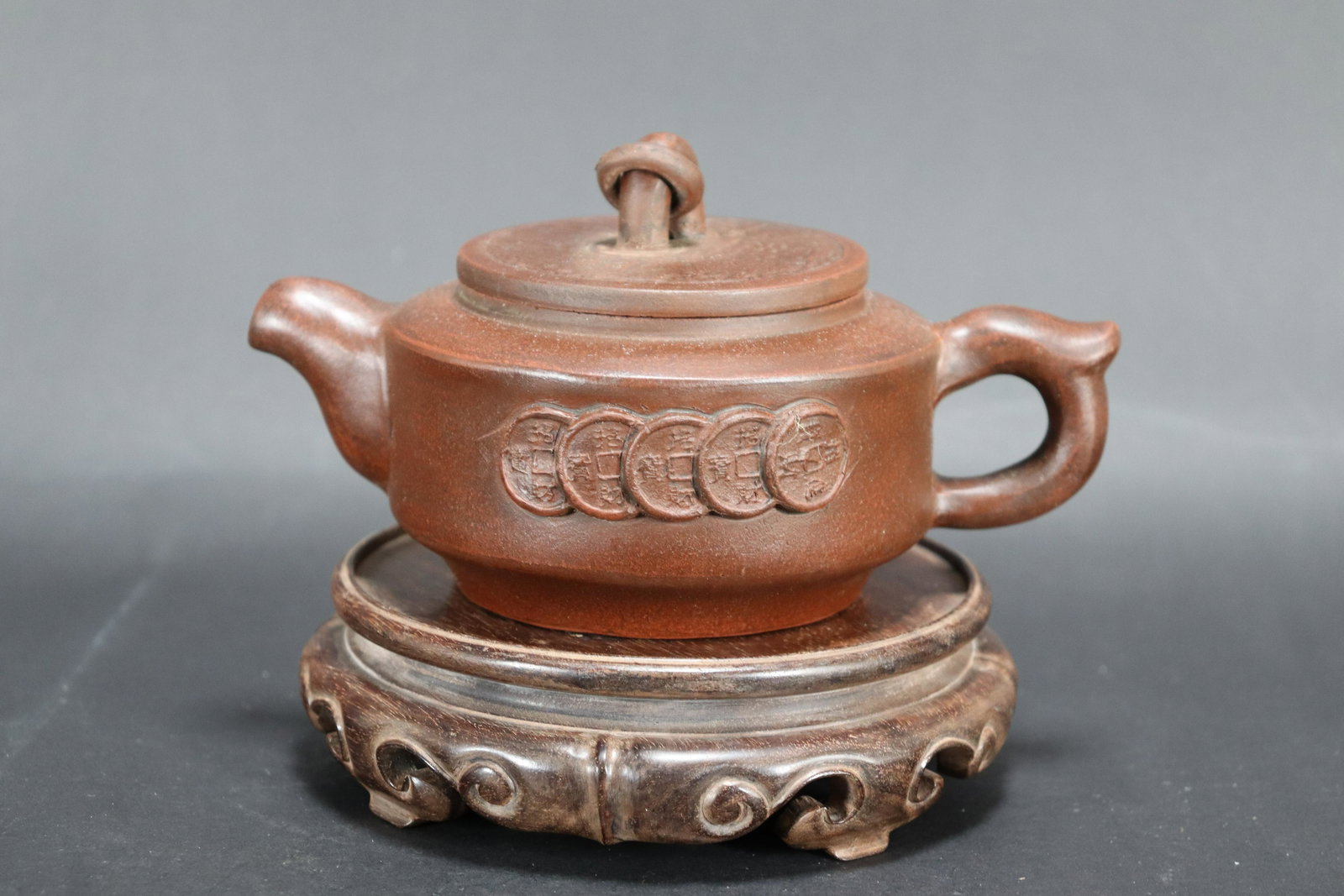 Chinese carved clay teapot: Chinese carved clay teapot. H: 3.5" x W: 6.5."
