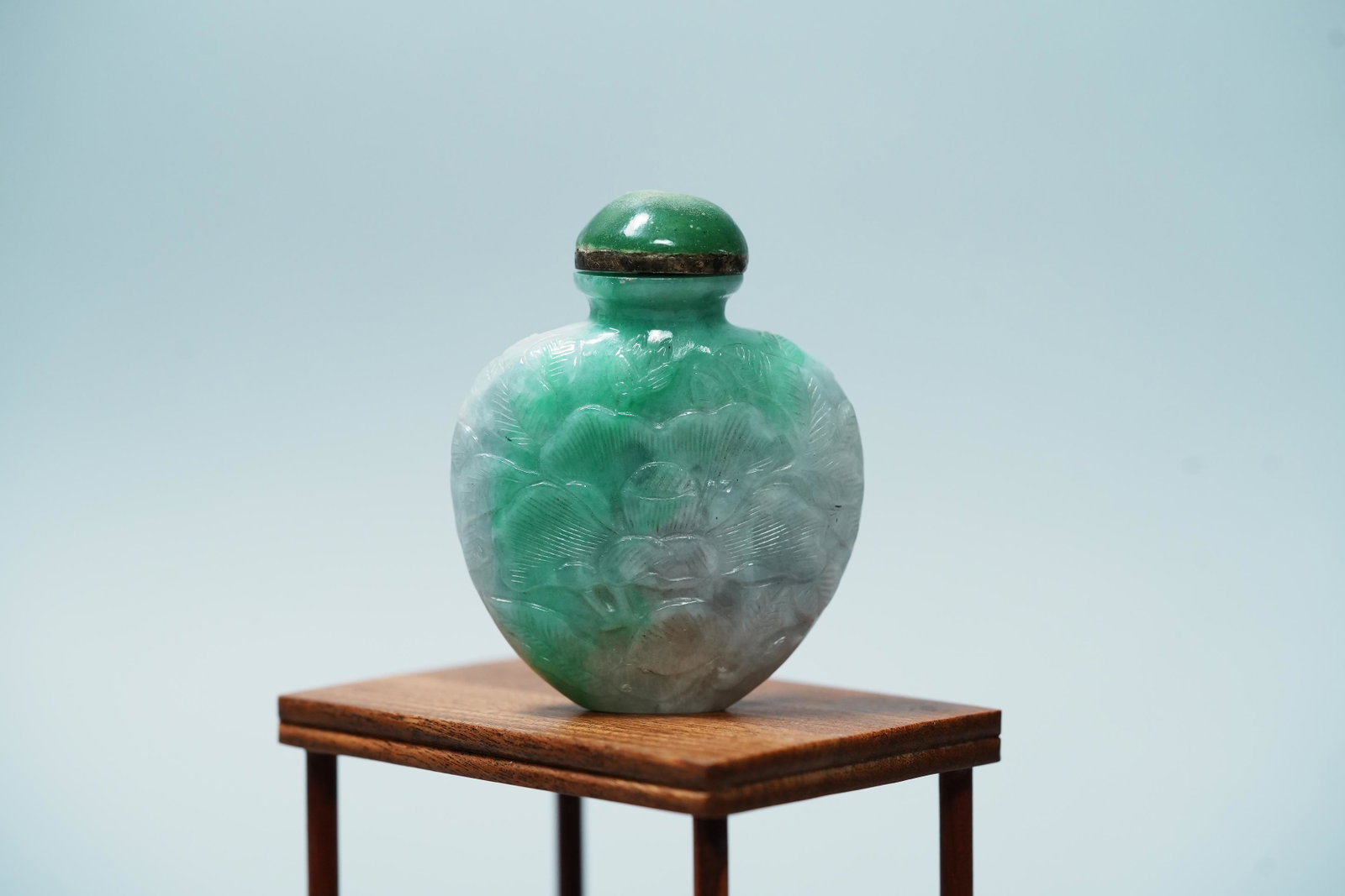 Chinese jadeite snuff bottle: Chinese vintage carved jadeite snuff bottle. H: 2.75" x W: 2.25." Estate of Yorba Linda.