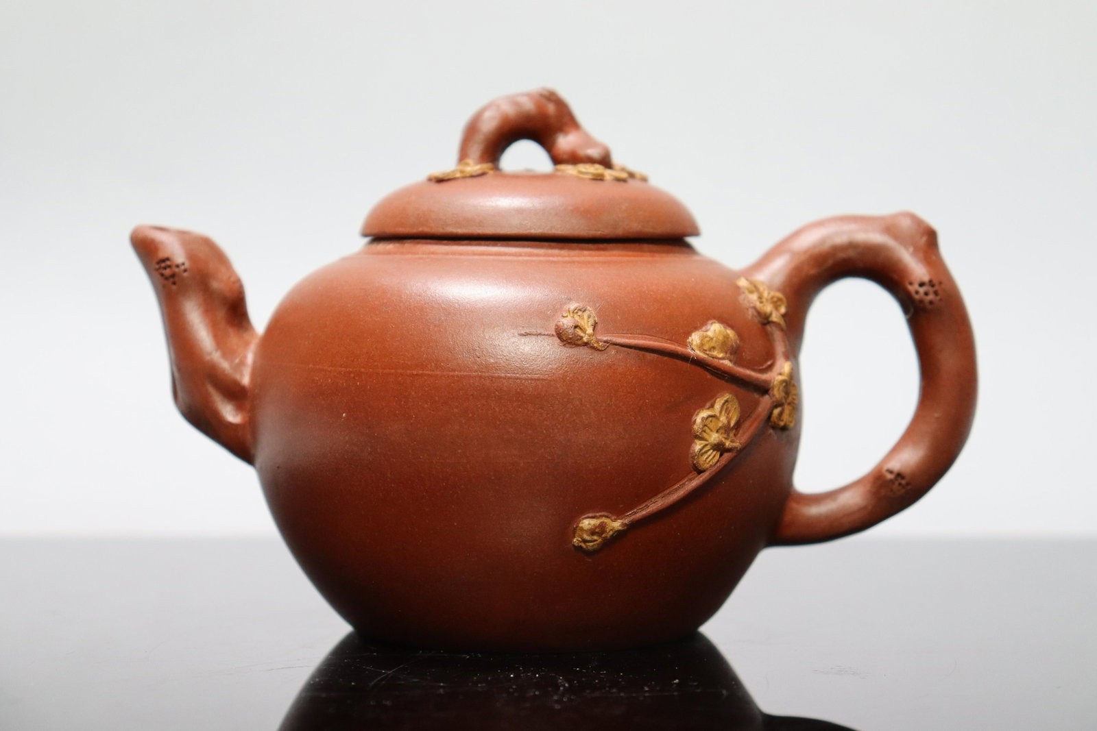 Chinese carved clay teapot: Chinese carved clay teapot. H: 4.25" x W: 6.25."