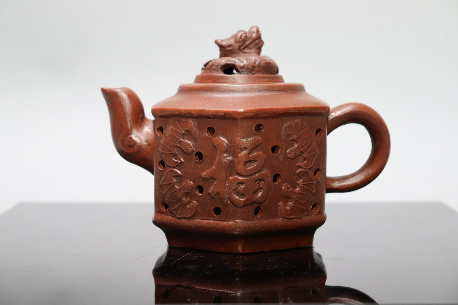Chinese carved clay teapot: Chinese carved clay teapot. H: 4.75" x W: 6.25."