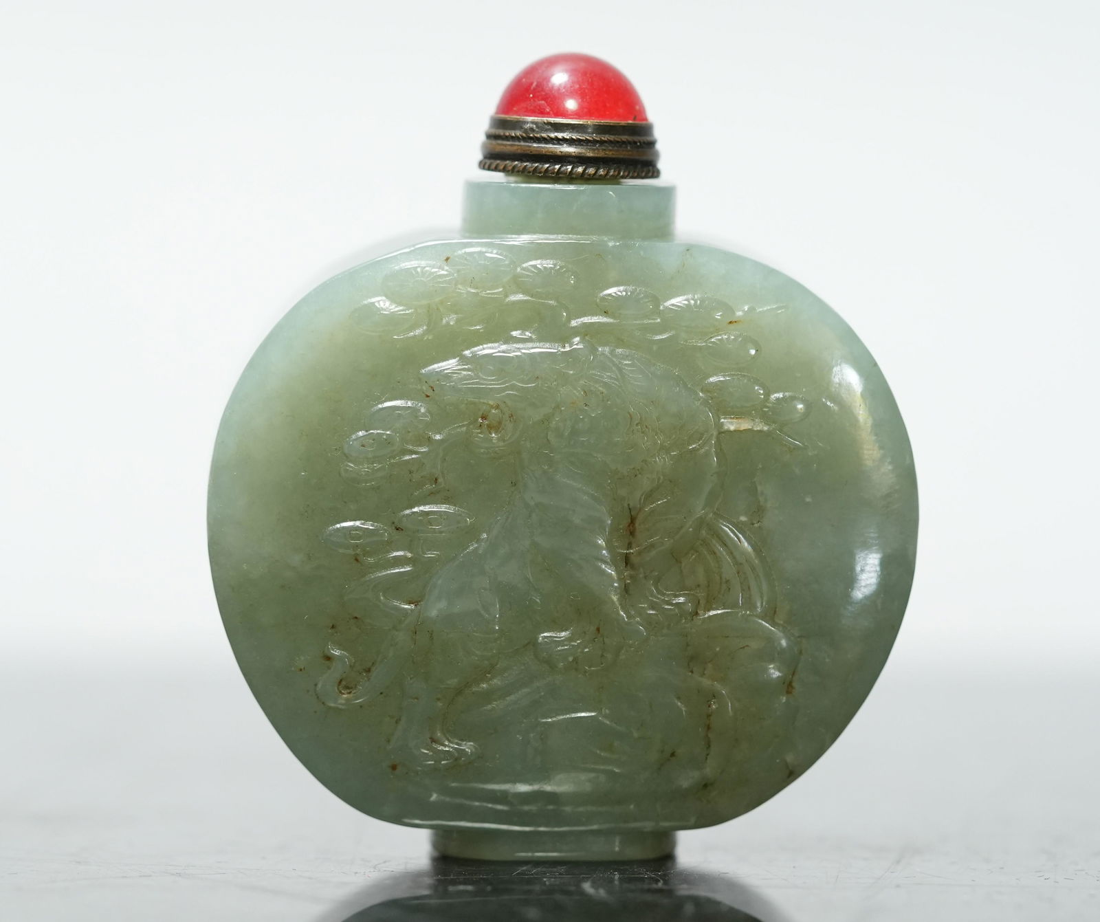 Chinese jade snuff bottle: Chinese celadon jade carved snuff bottle. H: 2.4" x W: 2.1."