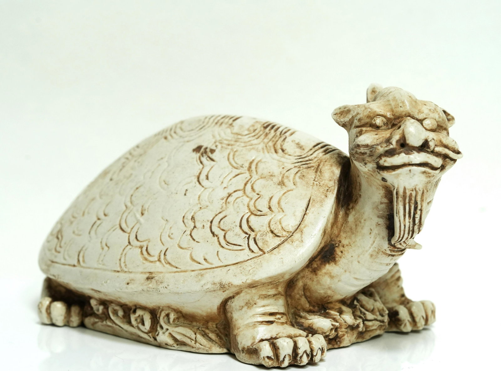 Chinese white glaze turtle: Chinese white glaze carved turtle. H: 4.25" x W: 6.75."