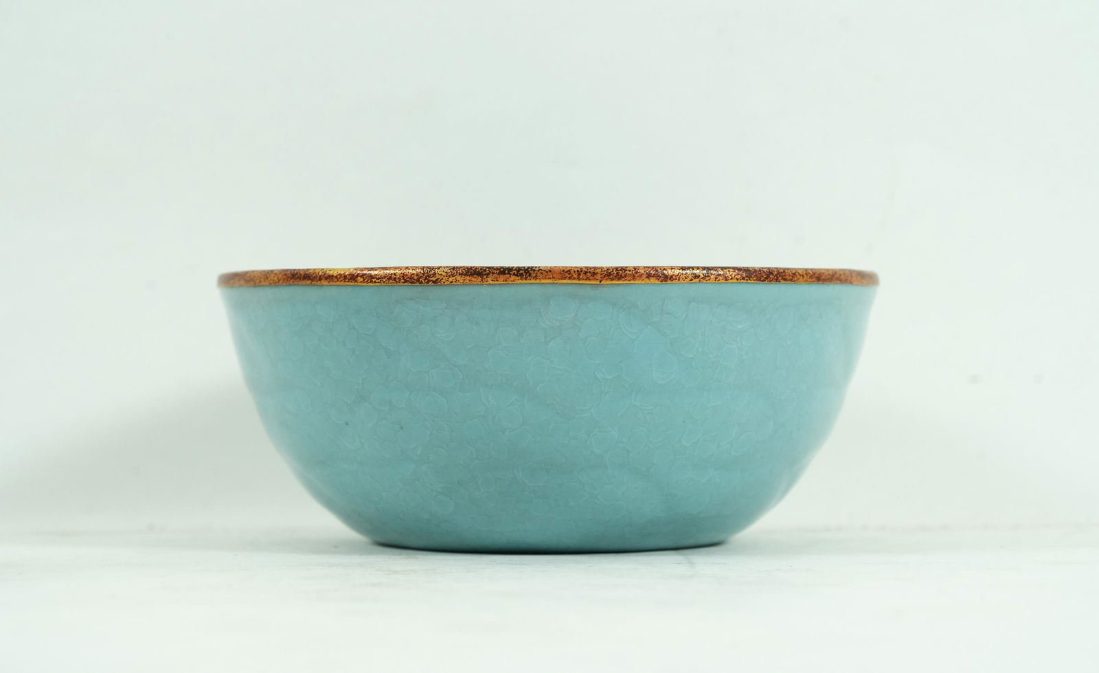 Chinese fine celadon bowl: Chinese fine celadon glaze crackled glaze bowl. Estate of Beverly Hills. H: 3" x W: 7."